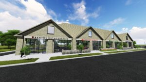 A modern strip mall with stone facades and various business storefronts